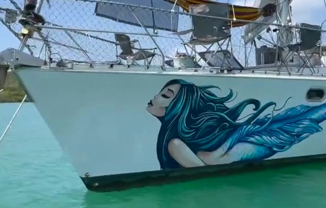 Water-level close of blue mermaid and wave hull art