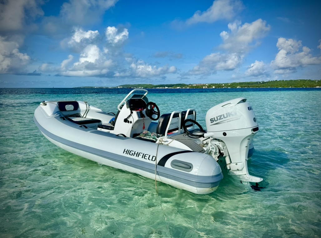 Highfield dinghy in clear Caribbean water with Suzuki 60HP outboard