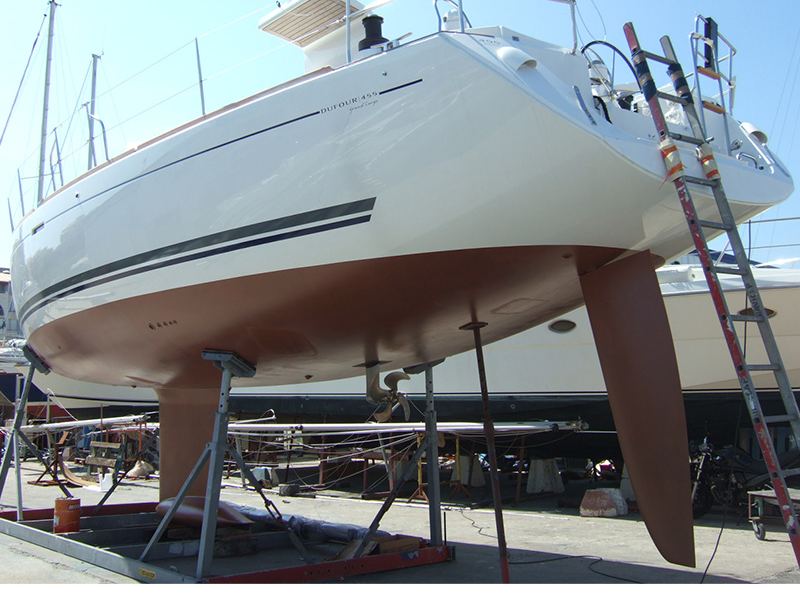 A sailboat on the hard with a fresh copper-colored CopperCoat hull